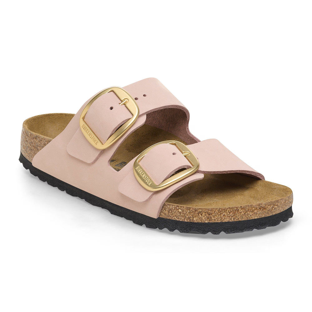 Pink sandal with gold buckles on a white background
