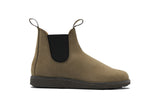 A single Chelsea boot in taupe suede with a black elastic side panel and a dark brown sole, shown in profile against a white background.
