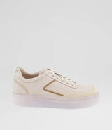 A low-top sneaker in off-white leather with a metallic gold side accent and a translucent clear sole, shown against a plain light gray background.