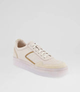 A low-top sneaker in off-white leather with a metallic gold side accent and a translucent clear sole, shown against a plain light gray background.
