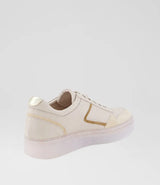 A low-top sneaker in off-white leather with metallic gold accents on the side and heel, featuring a chunky translucent sole, shown from a three-quarters rear angle on a light gray background.