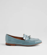 A single light blue patent leather penny loafer with a silver-tone tassel on the vamp, shown in profile against a light gray background.