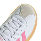 White sneaker with pink stripe and beige sole on a white background