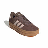 Black Adidas sneaker with white stripes on a white background