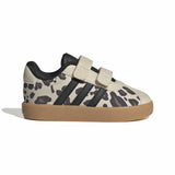 A toddler's low-top sneaker featuring a beige and black animal print pattern, black three-stripes, double hook-and-loop straps, and a gum sole, shown against a plain white background.