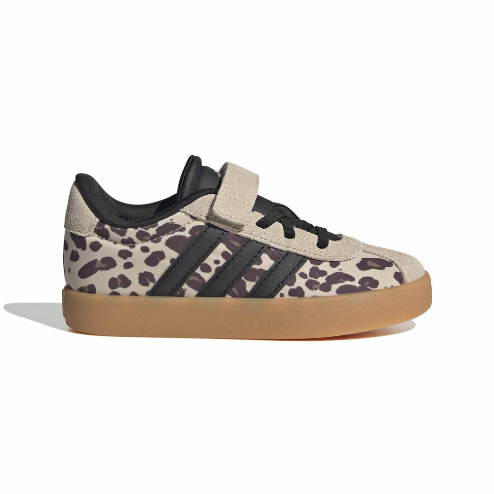 A single Adidas low-top sneaker with a beige and dark brown leopard print pattern, black three-stripes, a black hook-and-loop strap, and a gum sole, shown against a plain white background.