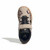 A single Adidas sneaker shown from a top-down view on a white background. The shoe features a beige suede and patterned upper with black laces, a black heel counter, and a brown gum sole.