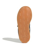 The tan rubber outsole of an Adidas shoe, showing the wavy tread pattern and embossed logo, photographed on a white background with a soft shadow.