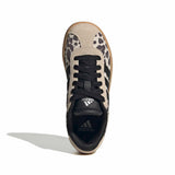 A single Adidas Sippdo sneaker shown from a top-down view on a white background. The shoe features a beige suede upper with black leopard print panels, black laces, a black collar with white Adidas branding, and a light brown gum sole.