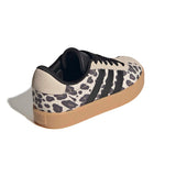 An Adidas low-top sneaker featuring a beige and black leopard print pattern on the side panels, black suede stripes, black laces, and a gum sole, shown on a white background with a soft shadow.
