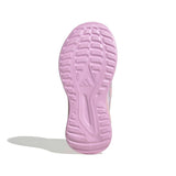 A close-up of a light pink athletic shoe sole, showing the tread pattern and embossed brand logo, on a white background with a soft shadow.