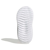 A white textured shoe sole with a wavy tread pattern, shown upright on a clean white background with a soft shadow to the left.
