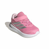 Pink Adidas children's shoe on a white background