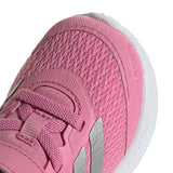Close-up of a pink children's shoe with white sole on a white background