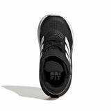 A single black and white toddler running shoe shown from a side profile view on a white background with a soft shadow.