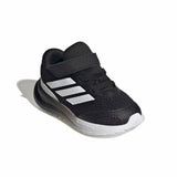Black Adidas shoe with white stripes on a white background