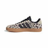 A single Adidas Gazelle sneaker featuring a beige and black leopard print upper, black laces, and a gum brown sole, shown from a side profile on a white background.