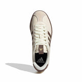 White Adidas sneaker with brown accents on a white background