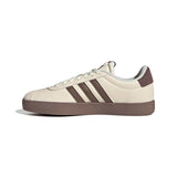 White sneaker with brown stripes on a white background