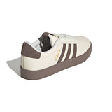 White and brown sneaker with three stripes on a white background