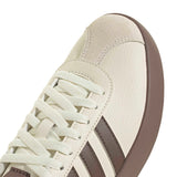 Close-up of a beige and brown sneaker with white laces on a white background