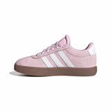 Pink Adidas sneaker with white stripes on a white background