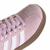 Close-up of a light purple sneaker with white stripes on a white background