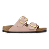 Pink sandal with gold buckles on a white background