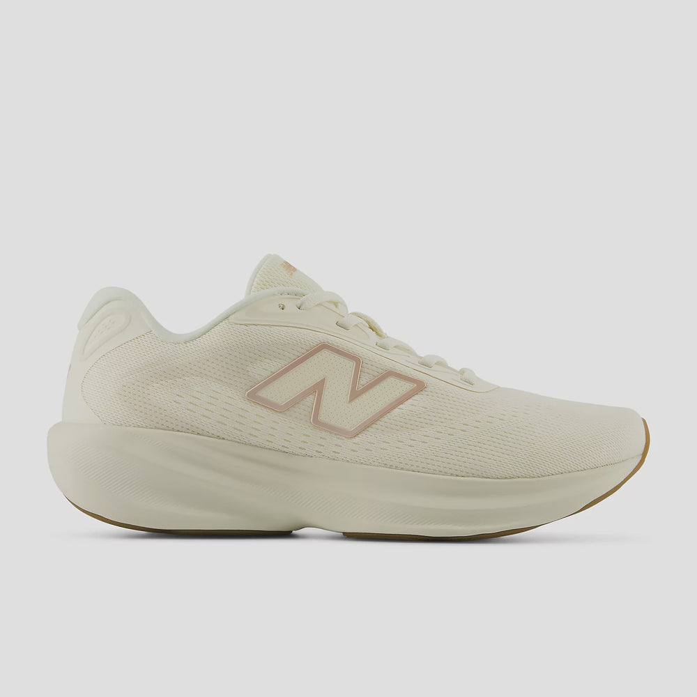 A New Balance running shoe in off-white with a dusty rose pink 'N' logo on the side, shown from a profile view against a light gray background.