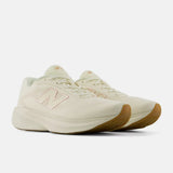 A pair of New Balance 1080v4 running shoes in off-white with a light pink 'N' logo and a gum brown outsole, shown against a light gray background.